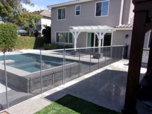 gray black pool fence installed in a home backyard