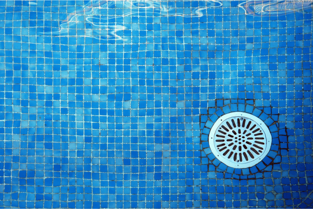 Underwater image in a swimming pool showing a pool drain