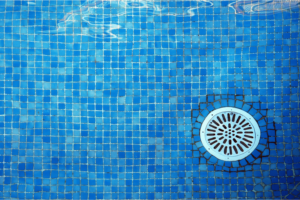 Underwater image in a swimming pool showing a pool drain