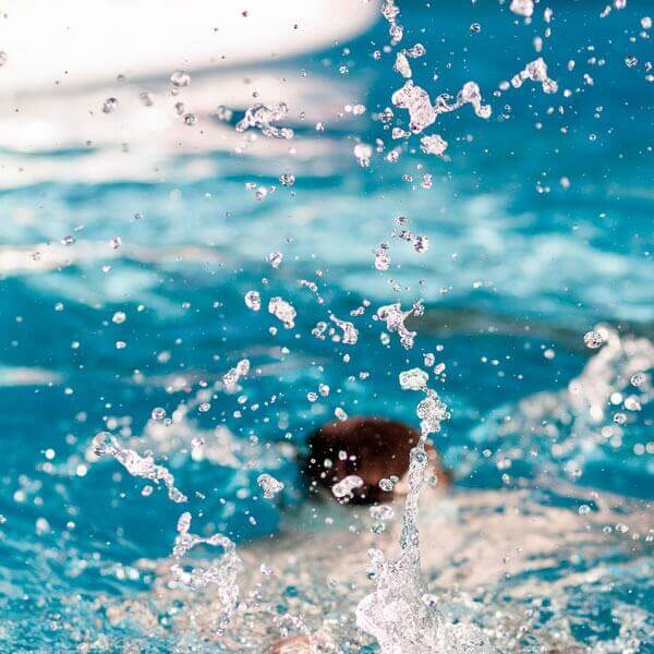 child jumping into water