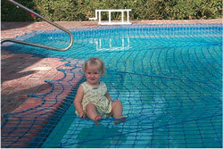 toddler sitting on pool net over water