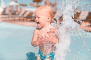 baby splashing in pool