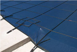 close up of mesh pool cover straps and anchors