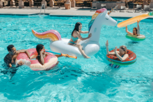 family enjoying swimming pool fun on floats