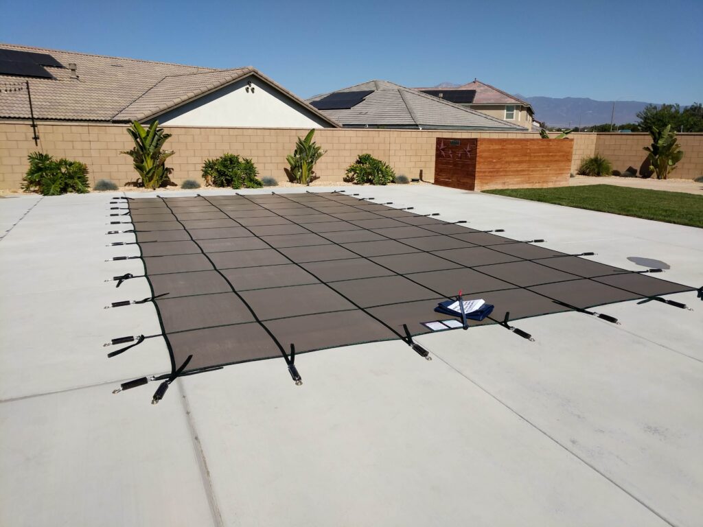 Winter pool safety cover installed on backyard pool