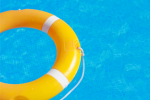 Yellow live saving buoy floating in a swimming pool
