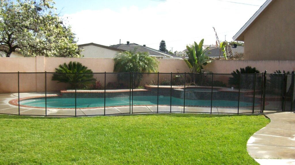 Photo showing pool fence installed in yard with pool