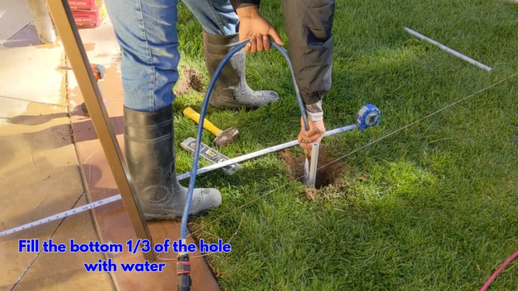 How To Install Your Pool Fence in Grass - Fill hole with water