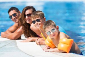 A family poses for a photo while in the swimming pool
