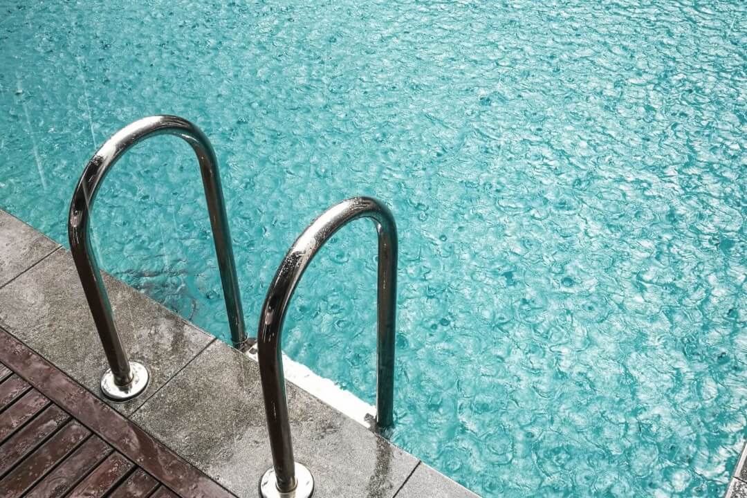 Outdoor swimming pool during a rain storm