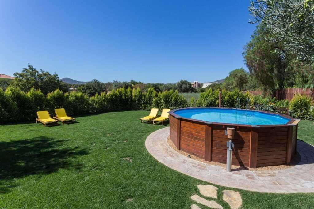 small above-ground pool in a lush backyard