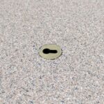 Brass Keyhole Anchor installed in a pool deck