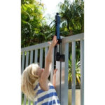 MagnaLatch S3 Black Gate Latch shown installed on gate with child reaching for the latch