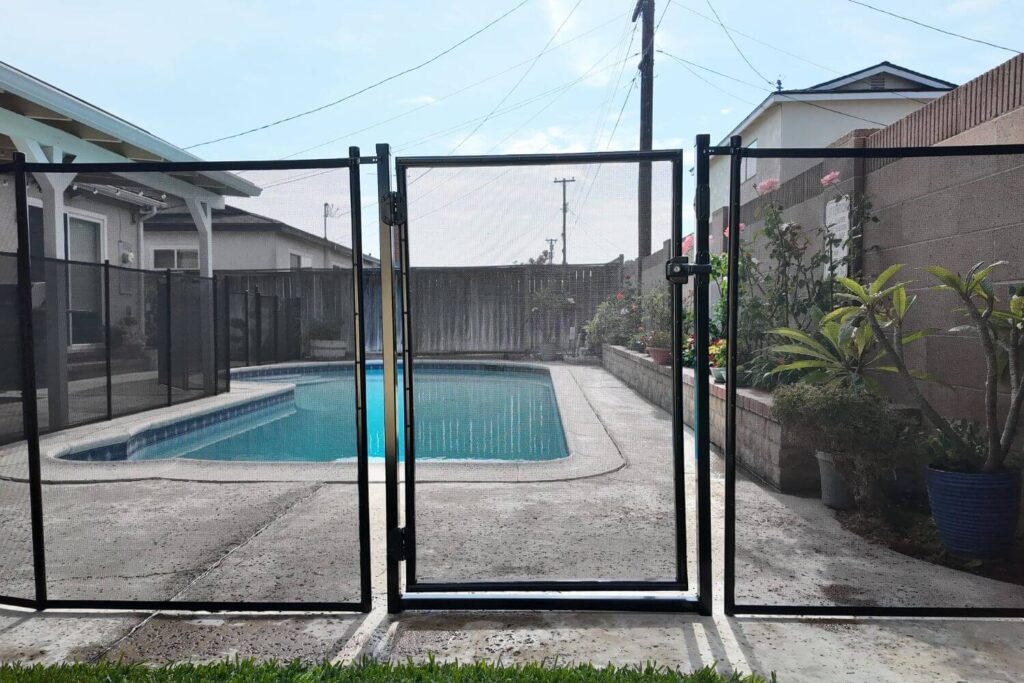 Black mesh pool fence around a pool