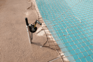 tan pool net installed over a swimming pool with Titan Tool