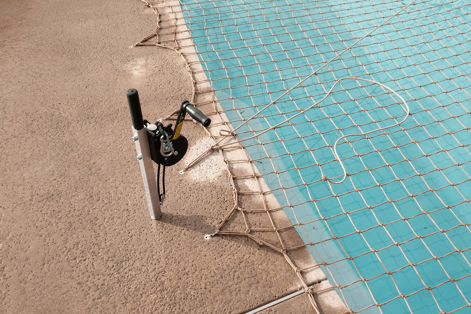 tan pool net installed over a swimming pool