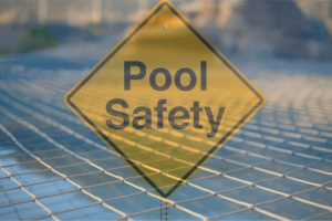 Faded out pool safety sign with safety pool netting over a pool in the background.