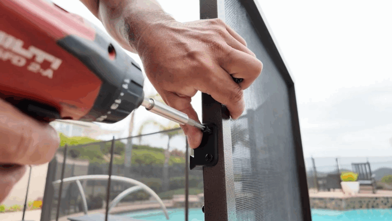 Installer removes mounting bracket from gate frame