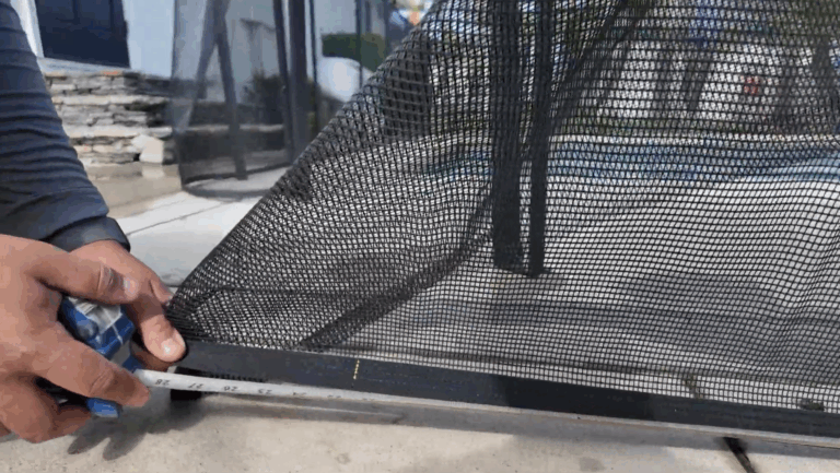 Installer measures from pole to mark on mesh