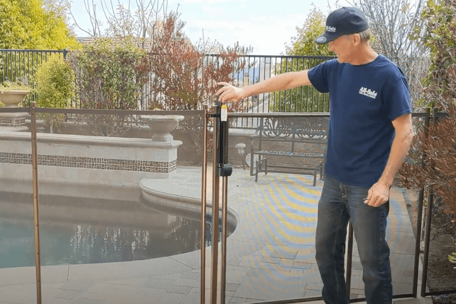 All-Safe professional pool fence installer finishing an installation at a residence