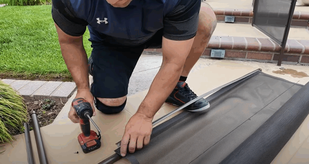 Installer using the "foot method" to stretch the mesh.