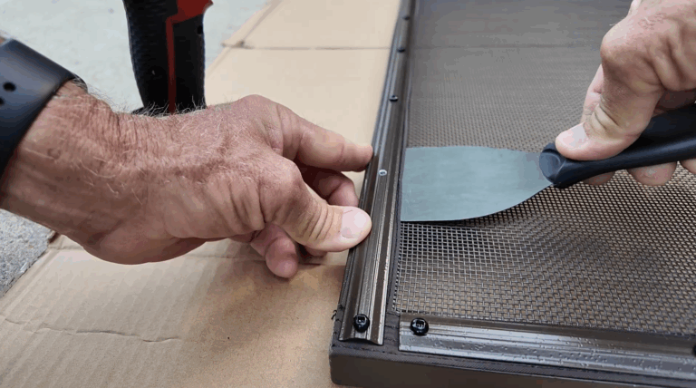 Installer uses a putty knife to push the mesh outward