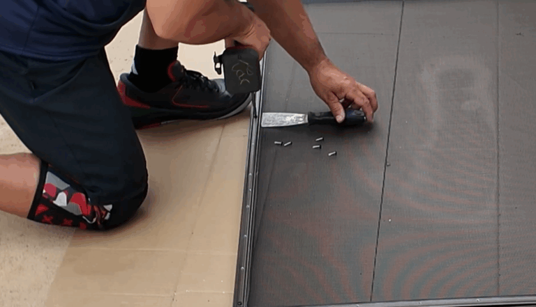 Installer inserts screws through molding into gate frame