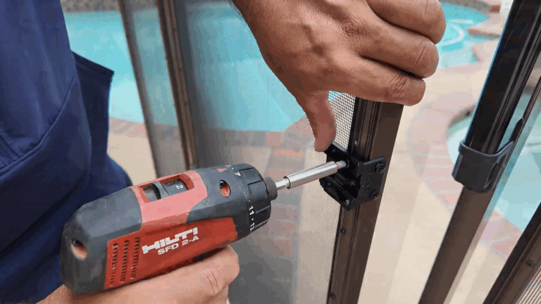 Installer screws the mounting bracket back onto the gate frame