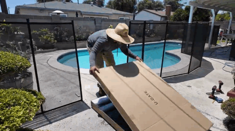 Installer places the box near the pre-drilled holes for the gate.