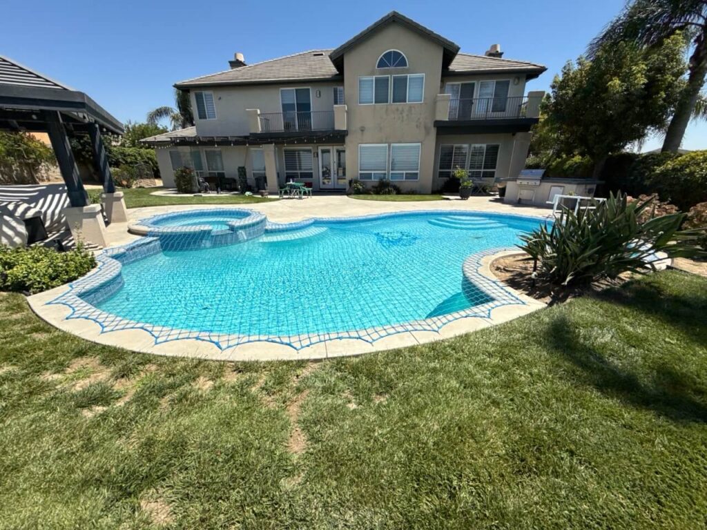 pool safety net installed over irregular shaped swimming pool