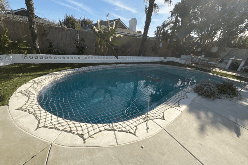 tan pool net installed over a swimming pool
