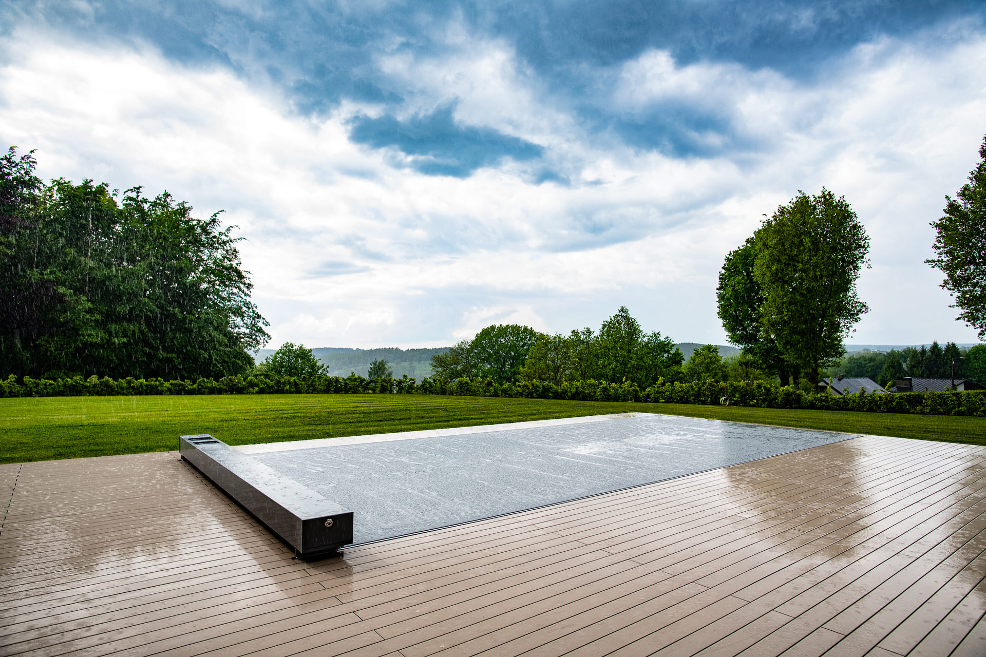 Pool fully covered by a top-track cover on a wood deck