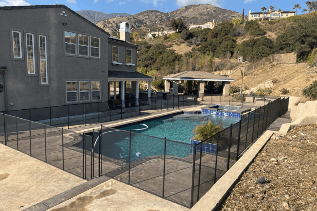 large home with a backyard pool that has a removable pool fence installed