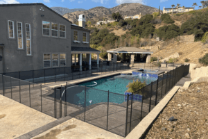 large home with a backyard pool that has a removable pool fence installed