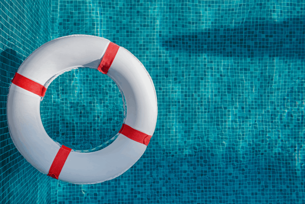 white and red pool flotation aid floating in a swimming pool
