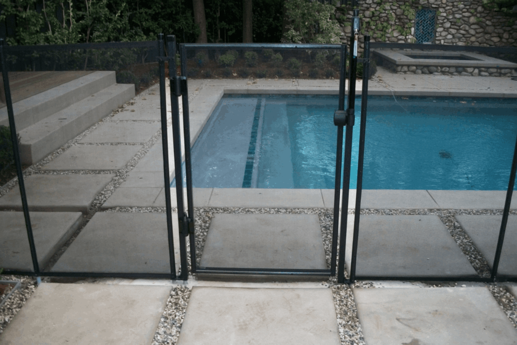 Close up showing mesh pool fence gate closed and locked
