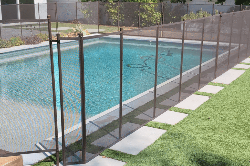 side angle of an installed removable mesh pool fence by All-Safe