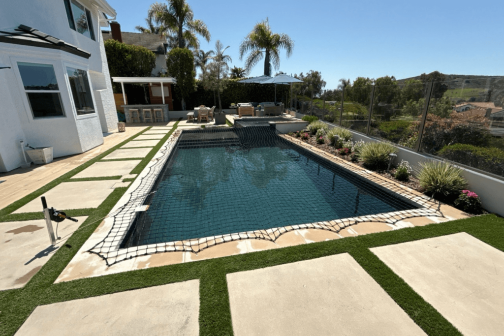 black pool net installed over a rectangular swimming pool
