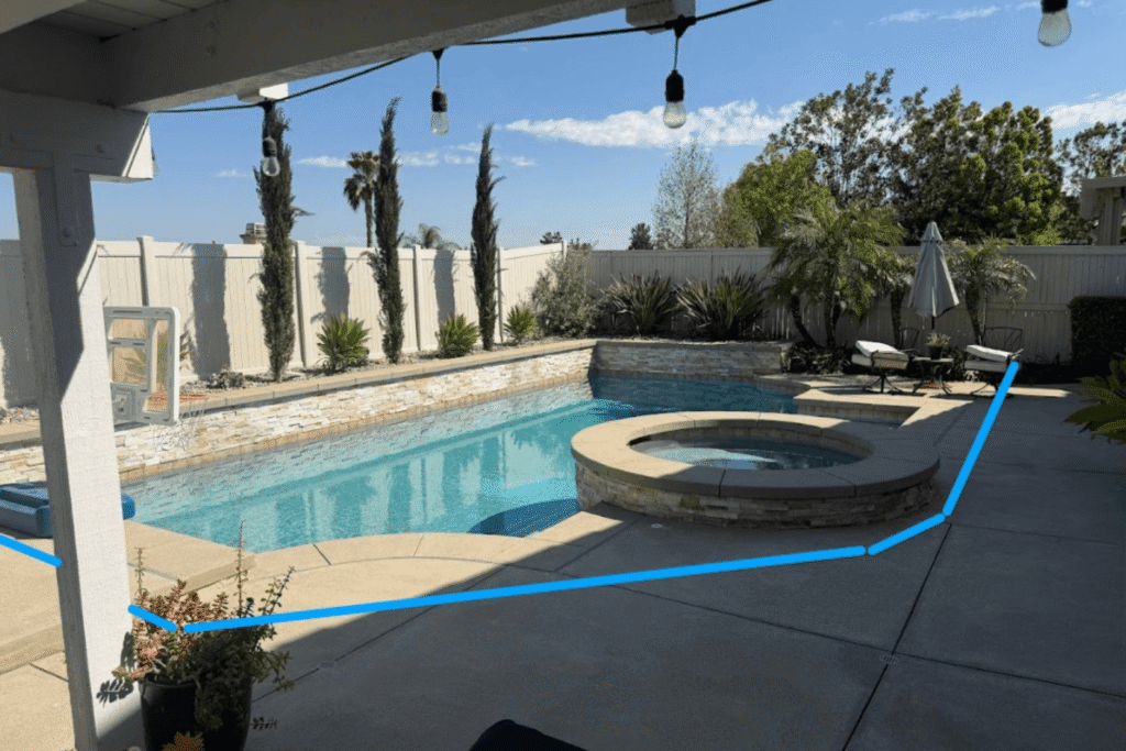 swimming pool showing blue perimeter lines where a pool fence is planned to be installed
