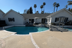 Backyard swimming pool with a bridge across the middle