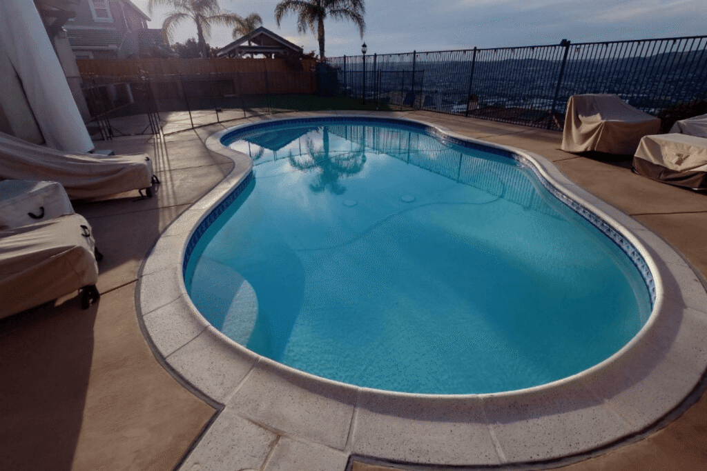 Backyard swimming pool before pool fence install