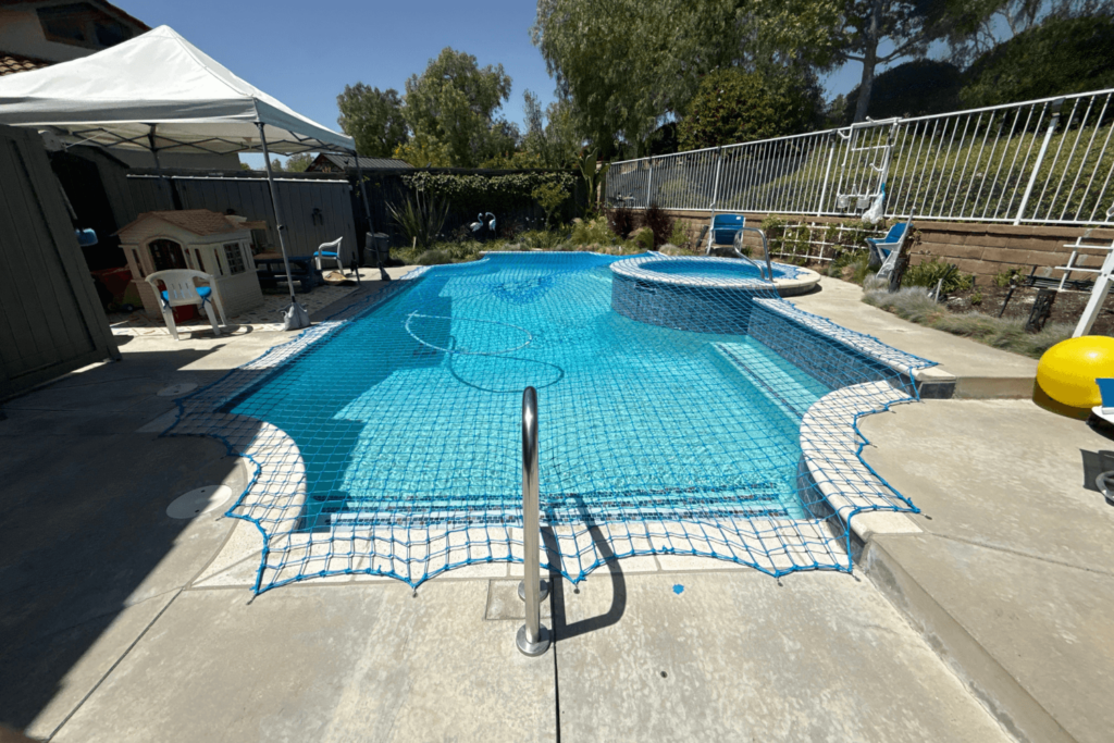 blue pool net installed over a swimming pool
