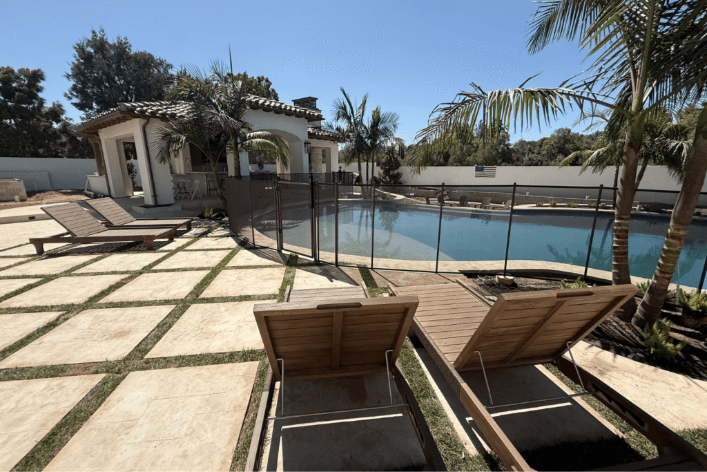 large backyard with swimming pool and lounge chairs