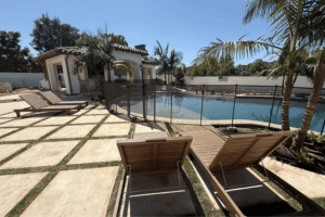 large backyard with swimming pool and lounge chairs