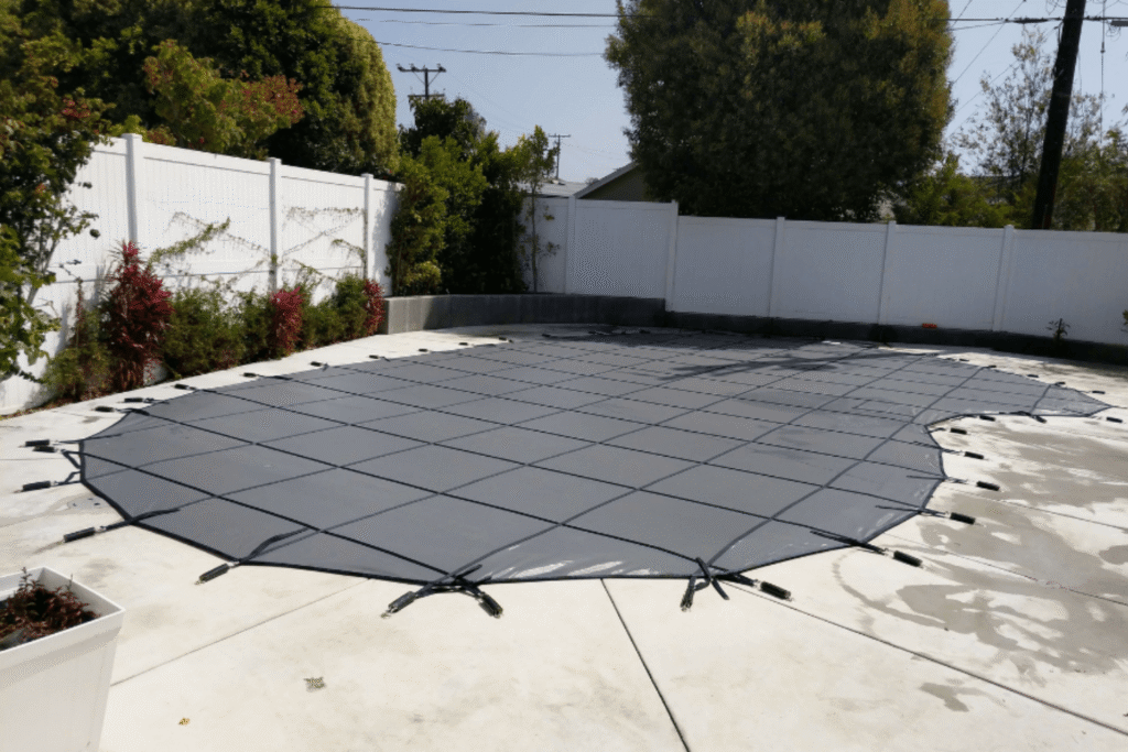 Black All-Safe winter pool cover installed