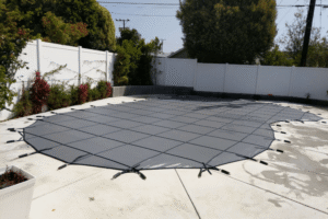 Black All-Safe winter pool cover installed