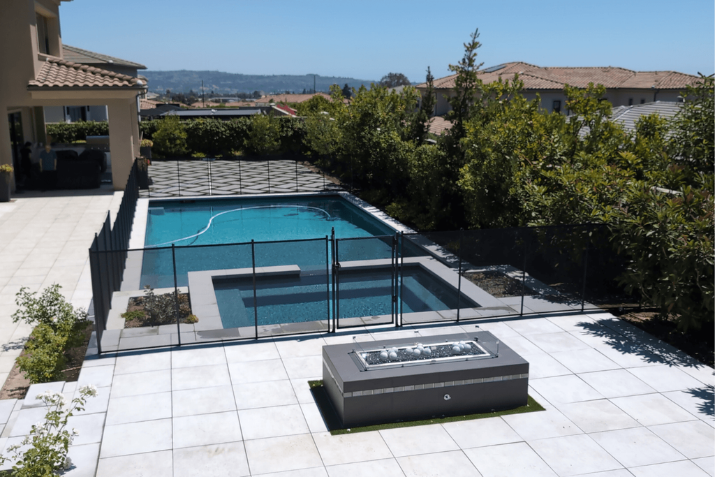 All-Safe Pool Black mesh removable pool fence installed around a rectangular swimming pool