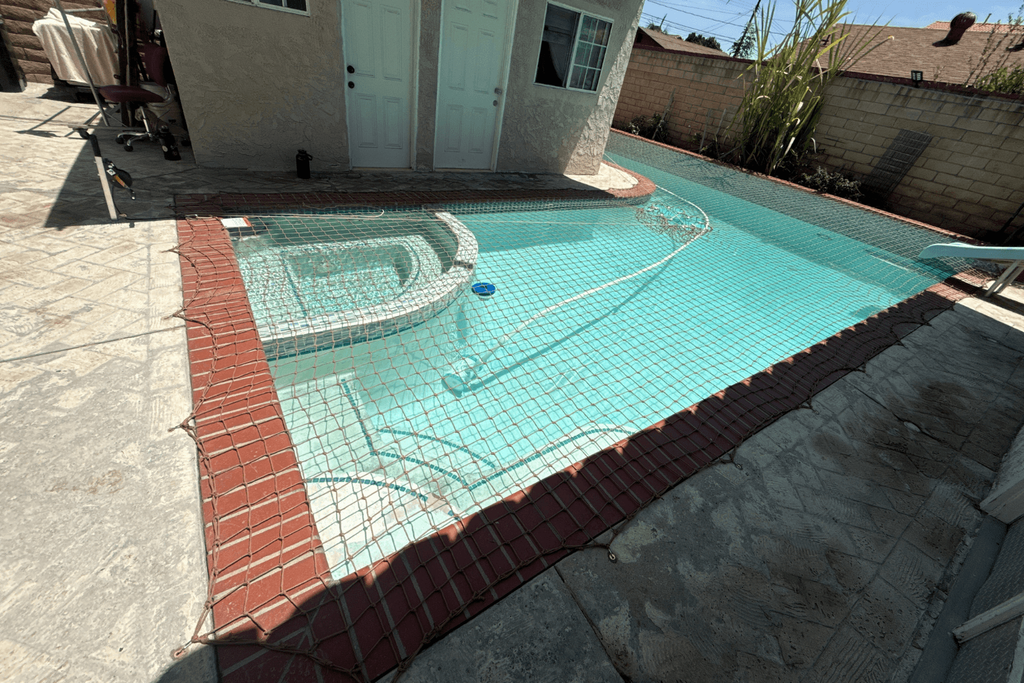 All-Safe tan pool safety net installed over a small swimming pool