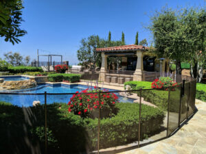 mesh black pool fence installed around swimming pool