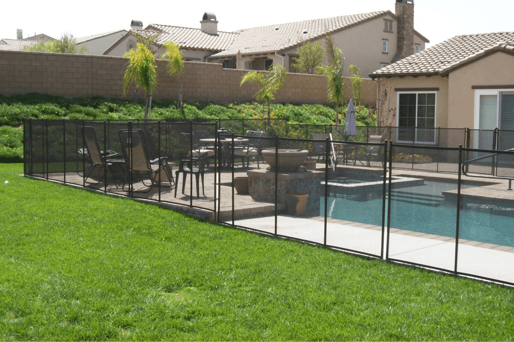 black mesh pool fence surrounding a swimming pool